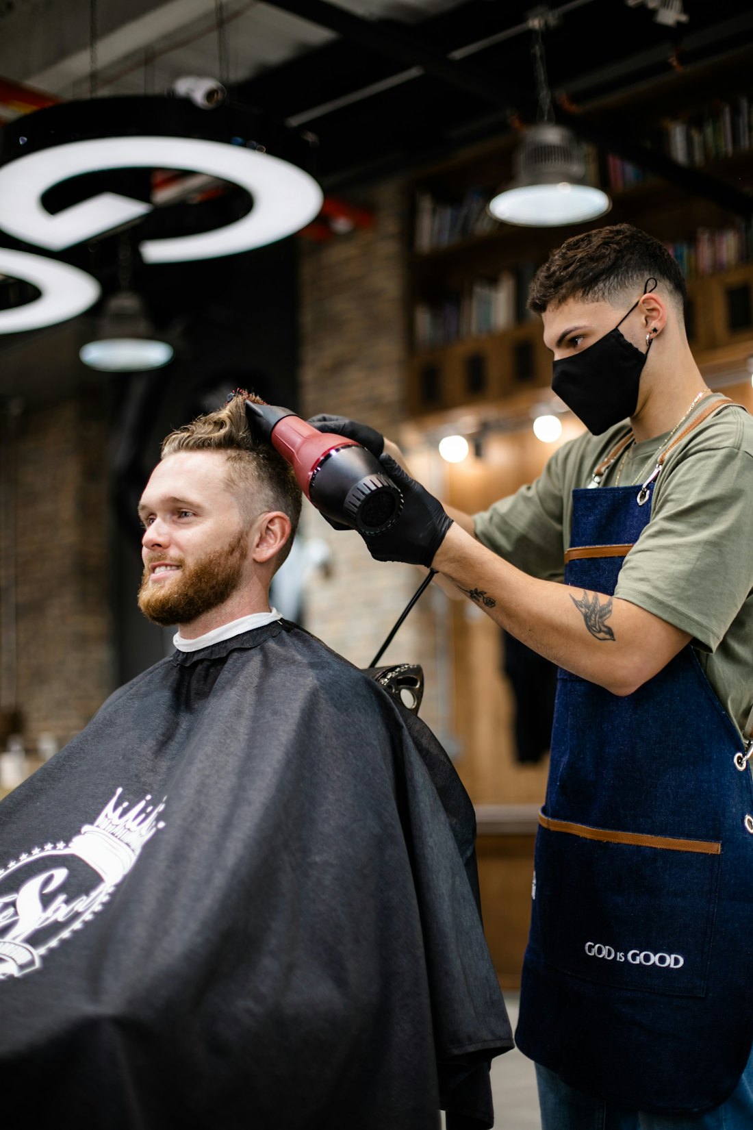 Barber blow-drying a client's hair